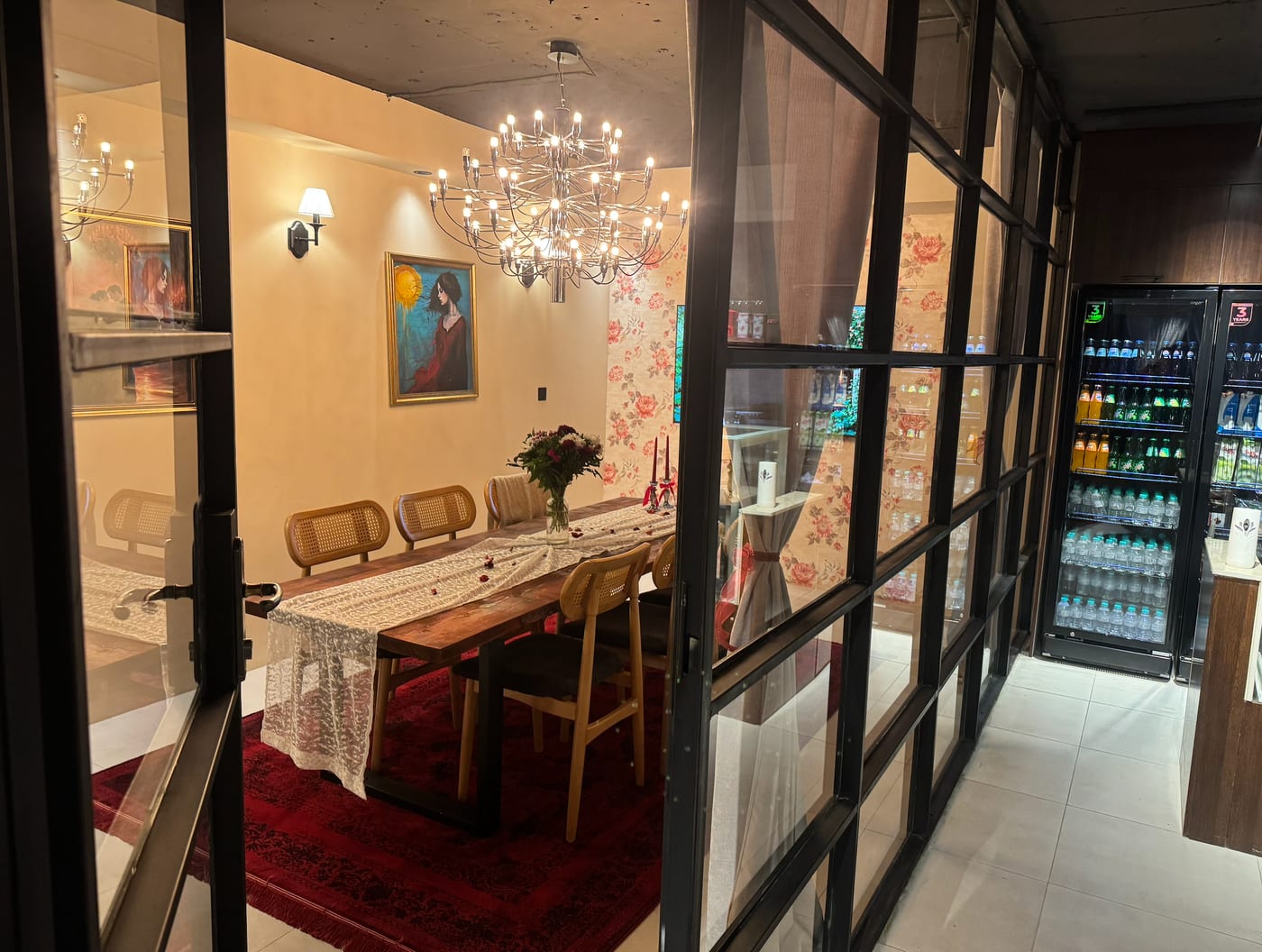 Inside Kurdila private room with wooden table and floral wallpaper