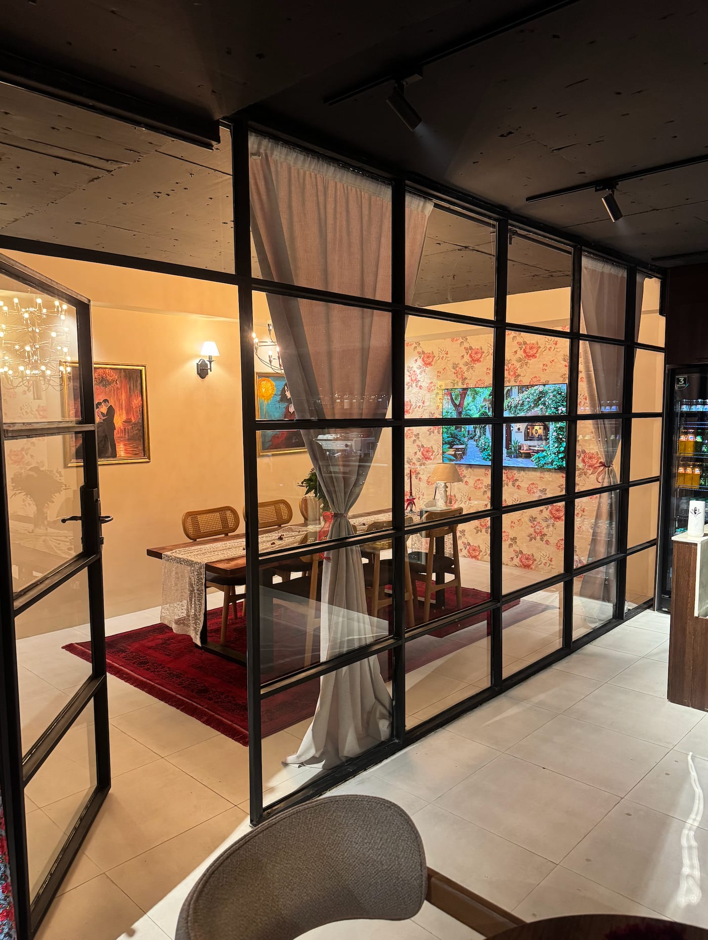 Glass-enclosed private room with screen for presentations